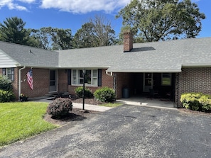 Driveway view with carport seating area