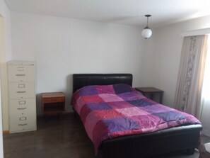 Master bedroom with a queen bed 