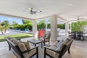 This covered outdoor space overlooks the gorgeous private backyard and offers  plenty of outdoor seating for relaxation and dining for 14.  This patio is located just off of the living room and can also be accessed via the sliding door in bedroom 4. 