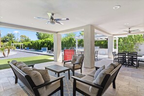 This covered outdoor space overlooks the gorgeous private backyard and offers  plenty of outdoor seating for relaxation and dining for 14.  This patio is located just off of the living room and can also be accessed via the sliding door in bedroom 4.