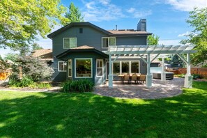 Back of home, big yard, large patio, table and chair seat 8