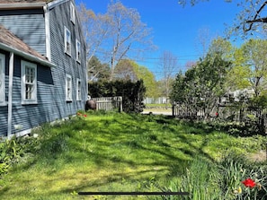 View from side of house near back mini deck and porch entrance.