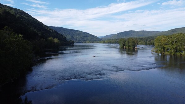 An aerial view of a a kayaker crossing the river near the islands just north of the house.