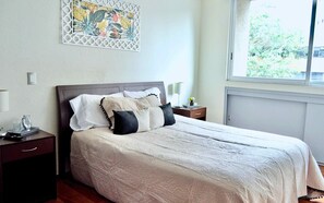 Second bedroom with a queen size bed.