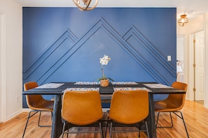 Dining room is flooded with natural light, selfie worthy mtn wall, comfy seating