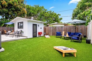 Play cornhole and unwind in this sunny backyard with a private guest suite.