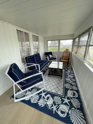 Rock away the evening as the sun sets from the screened in porch