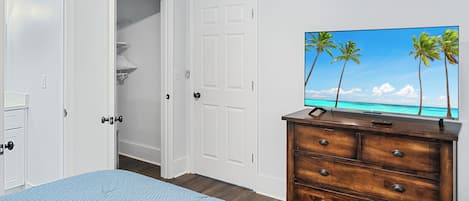 Bedroom with queen mattress, SmartTV, closet, and bathroom