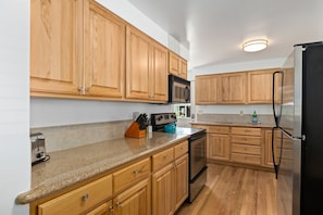 This updated kitchen has tons of counterspace and all the utensils and cooking basics needed to make full meals and save money on eating out. The small breakfast table can fold out to accommodate up to four people.