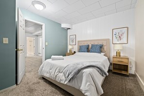 Super comfortable queen bed in the downstairs bedroom #1 with two touch-activated nightstand lamps each with built-in USB power ports.