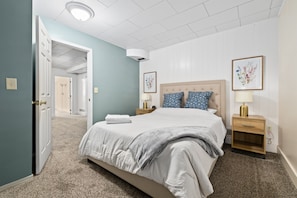 Super comfortable queen bed in the downstairs bedroom #1 with two touch-activated nightstand lamps each with built-in USB power ports.