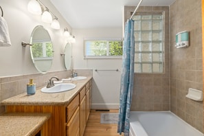 Bathroom #1 upstairs with dual vanities and bath/shower combo.