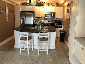 Straight ahead is your fully equipped kitchen, with 2 bar stools