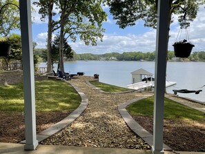 view of rear yard and lake from lower patio