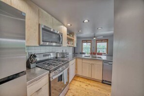Main level: Kitchen has stainless appliances and hardwood floors.