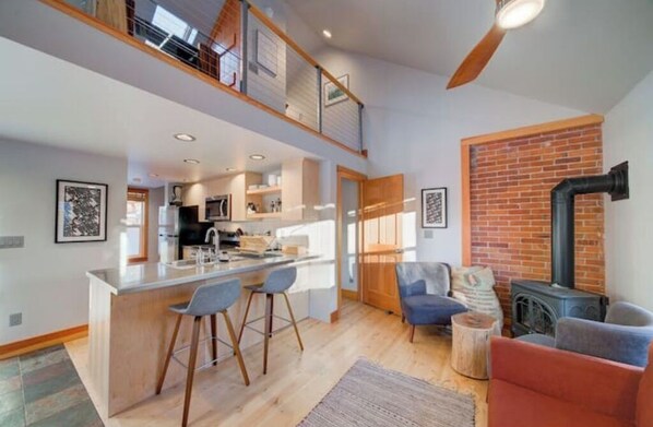 Main level: brand-new kitchen, living area, new full bathroom behind kitchen