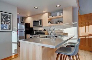 Main level: kitchen has bar seating for two.
