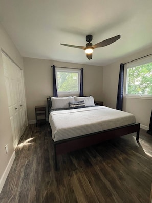 Master bedroom inc lake view windows and a king-sized bed + closet & dresser