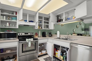 Fully stocked: spices, Cuisinart pots, dishes, glassware, plastic & paper goods