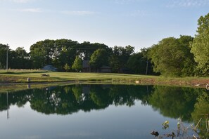 Pond in front of cabin.  Great fishing and a couple kayaks are available. 