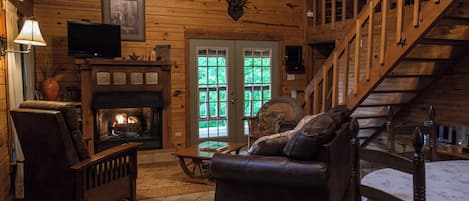 Living room, gas fireplace and french doors that open to the wrap around porch.