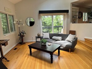 cozy living room with large tv and lots of natural light