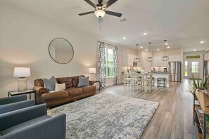 Stunning Living room area with beautiful decor that flows into the dining space and kitchen.