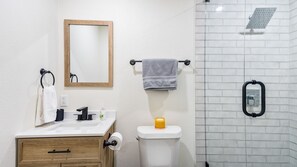 Bathroom #3 - with tub/shower combo, toilet, and cabinet sink and mirror.