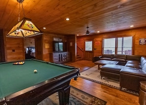 Cozy game room ambiance w/ pool table and arcade games!