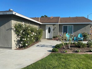 Front entrance with garage and driveway on left