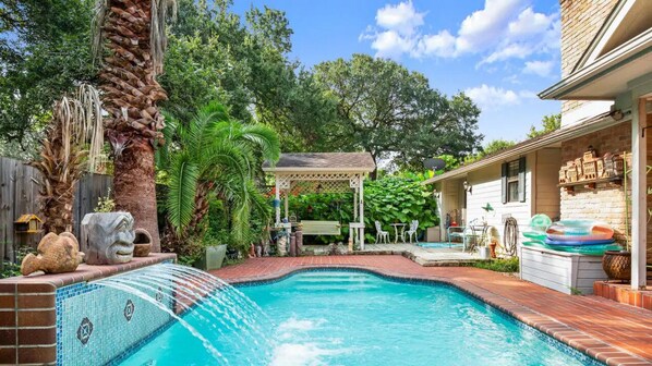 Beautiful backyard with pool, grill, and plenty of places to hang out