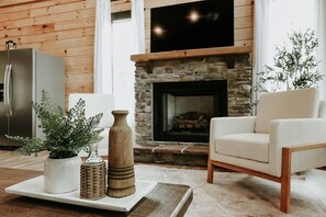 Stacked stone gas fireplace.