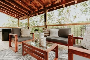 Cozy covered porch with outdoor seating.