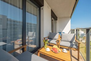 Private balcony with a table and chairs, offering a serene outdoor seating area and a great view.

