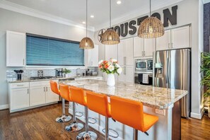Very large kitchen island with barstool seating for 5 and a fully stocked kitchen with place setting for 16 people - kitchen has all the amenities needed for your entertaining needs