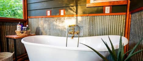 Enjoy the peace of our screened in porch claw tub.