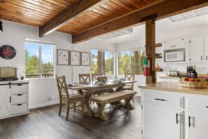 Enjoy a homecooked meal or family board game session at the comfortable dining table that's open to the kitchen! The dining table sits 8 comfortably.