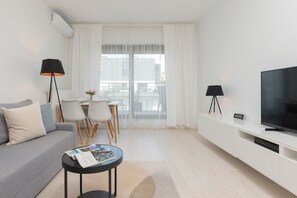 Spacious living area with access to a balcony, featuring sleek and elegant decor.

