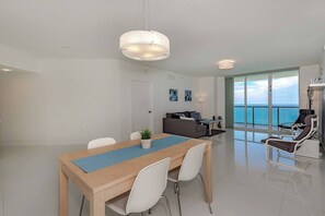 The dining room comfortably accommodates four people, providing a cozy setting for shared meals and memorable gatherings.