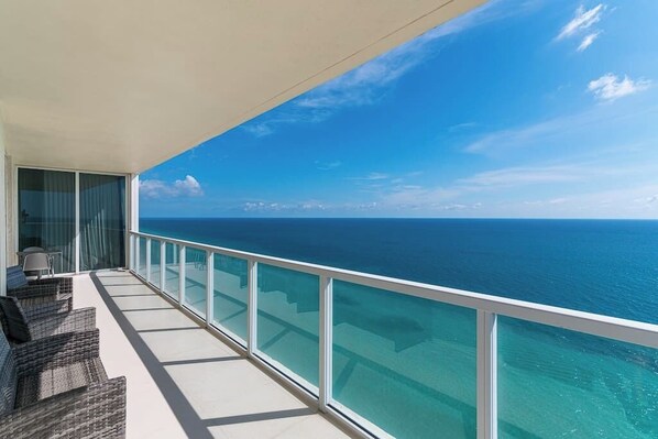 Enjoy the spacious balcony with stunning ocean views, perfect for relaxation and soaking in the beauty of the vast waters.