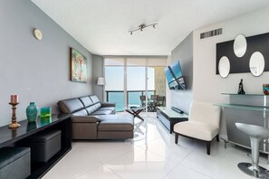 Relax in our inviting living room, furnished with modern decor and ample seating for enjoying time together.