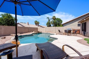 Sparkling pool with lounge chairs and plenty of outdoor seating