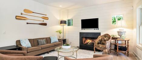 Family room with large TV and seasonal gas fireplace