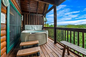 The back deck has a hot tub, additional seating areas, and stunning mountain views.