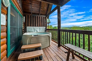 The back deck has a hot tub, additional seating areas, and stunning mountain views.