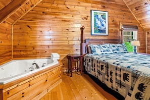 The master bedroom upstairs includes a comfortable king bed, in-room jacuzzi tub, and in-room fireplace.