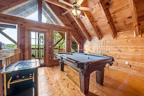 The game room in the loft includes a full-sized pool table and arcade games that provide hours of fun for the whole group.