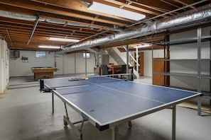 Unleash your competitive spirit in this gameroom with table tennis and billiards