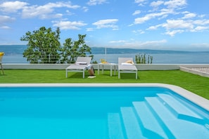 A private swimming pool 9m x 3,7m, a sun deck area with artificial grass, and with 4 deck chairs