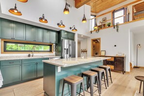 Outfitted kitchen with island and access to half bath